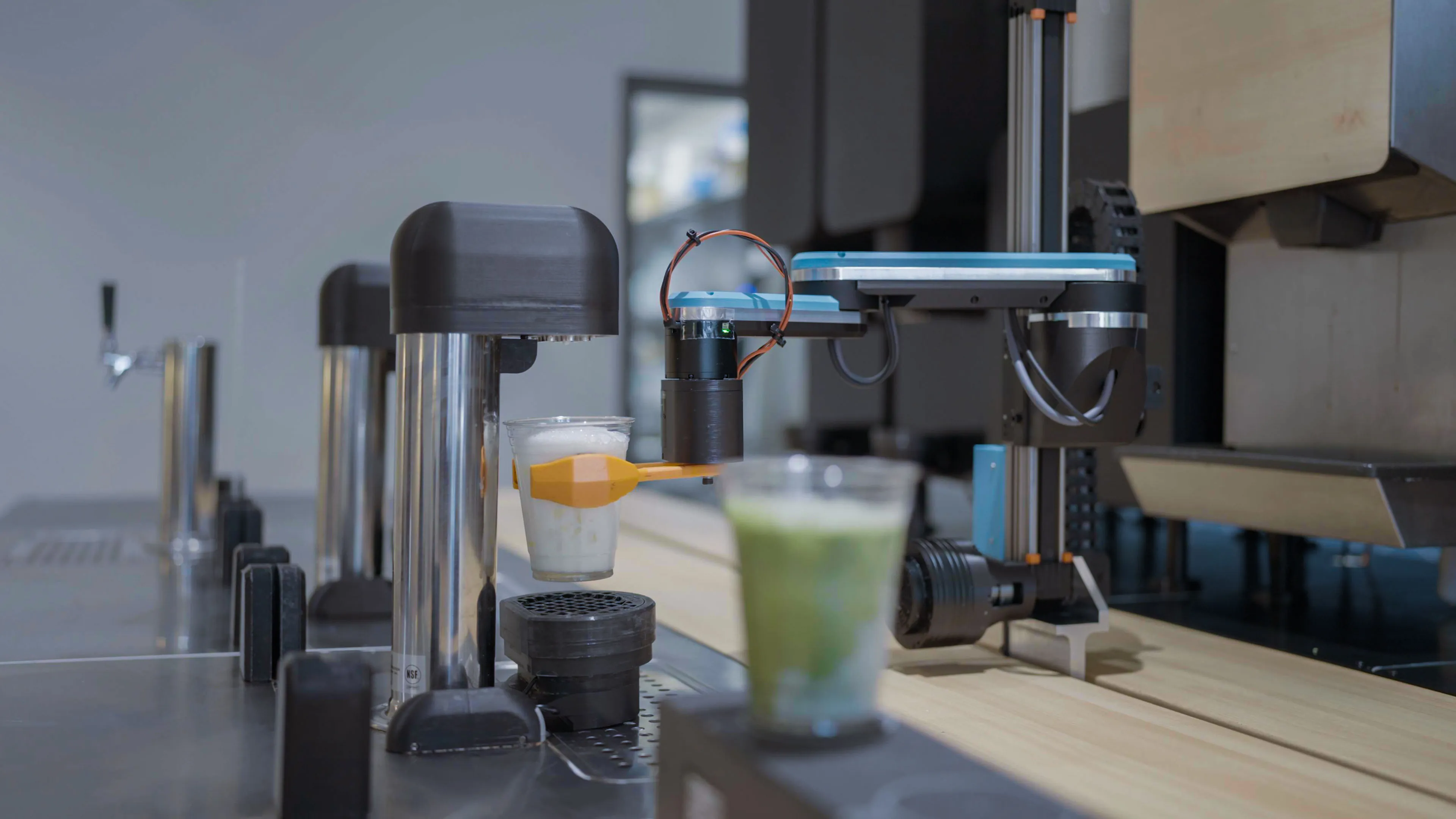 Side view of the Yummy Future robot arm and cups